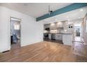 Open concept kitchen with granite countertops and stainless steel appliances at 4820 Newton St, Denver, CO 80221