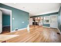 Light-filled living room featuring hardwood floors and a view of the kitchen at 4820 Newton St, Denver, CO 80221