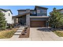 Charming two-story home featuring a covered front porch and a two-car garage at 10796 Truckee Cir, Commerce City, CO 80022
