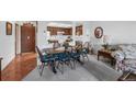 Inviting dining area with a wooden table, seating for six, and an open view to the kitchen at 13902 E Marina Dr # 303, Aurora, CO 80014