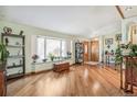Bright living room featuring hardwood floors, a large window seat, and a welcoming atmosphere at 7681 S Jellison St, Littleton, CO 80127