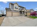 Charming two-story home with a three-car garage and stone-accented facade at 20888 E 51St Pl, Denver, CO 80249