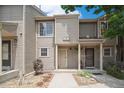 Charming townhome featuring a cozy front porch and well-maintained landscaping at 11147 W 17Th Ave # 105, Lakewood, CO 80215