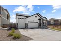 Attractive single Gathering home with stone accents, a three car garage and a well-maintained lawn at 16218 E 111Th Pl, Commerce City, CO 80022