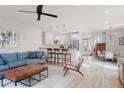 Bright open-concept floor plan with hardwood floors, living room, kitchen, and dining area at 2034 Newton St, Denver, CO 80211
