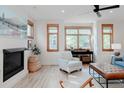 Cozy living room with fireplace, large windows and comfortable seating area at 2034 Newton St, Denver, CO 80211
