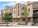 Handsome townhomes featuring stone accents, modern siding, and well-kept landscaping at 11132 Via Lata Dr, Broomfield, CO 80020