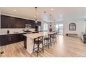 Bright kitchen with a large island, bar stool seating and easy access to the dining area at 1420 E Witherspoon Dr, Elizabeth, CO 80107