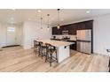 Modern kitchen with stainless steel appliances, spacious island, and stylish pendant lighting at 1420 E Witherspoon Dr, Elizabeth, CO 80107