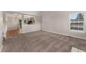 Bright living room featuring neutral carpeting, large windows, and an open concept design at 11532 Newland St, Westminster, CO 80020
