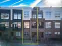 Brick townhome exterior showing multi-level architecture and modern design under a partly cloudy sky at 2706 Blake St, Denver, CO 80205