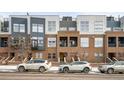 Modern townhome exterior with a brick facade, grey siding, and street parking available in front at 2706 Blake St, Denver, CO 80205