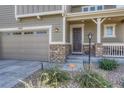 Front entrance with stone accents and a covered porch at 27192 E Frost Pl, Aurora, CO 80016