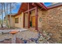 Stunning front entrance featuring stone accents and a well-manicured front yard at 2433 Dogie Spur, Golden, CO 80403