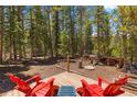 Inviting backyard deck features red Adirondack chairs and a small side table, perfect for relaxing outdoors at 91 Slalom Dr, Breckenridge, CO 80424