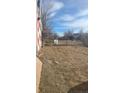 Empty lot with dirt and some debris, behind the building at 3818 S Lowell Blvd, Sheridan, CO 80236