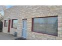 Building facade featuring stone exterior and red accents at 3818 S Lowell Blvd, Sheridan, CO 80236