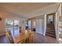 Inviting dining area with staircase access and ample natural light from a large window at 1922 S Ivory Way, Aurora, CO 80013