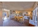 Bright dining room featuring wood floors, natural light, and classic furnishings at 1922 S Ivory Way, Aurora, CO 80013