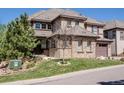 Charming home exterior with lush landscaping and well-maintained front yard at 6878 Northstar Ct, Castle Rock, CO 80108