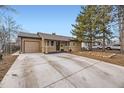 Inviting home featuring a spacious driveway and a well-manicured front yard at 1519 S Lowell Blvd, Denver, CO 80219