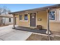 Welcoming front porch with decorative details, creating a charming entry to the home at 1519 S Lowell Blvd, Denver, CO 80219
