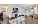 Bright living room with a decorative fireplace and a comfortable seating area at 1519 S Lowell Blvd, Denver, CO 80219