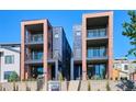 Modern townhomes featuring brick and metal accents, and multiple balconies at 1819 N Grove St, Denver, CO 80204