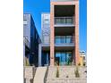 Modern townhome with brick and metal accents, three balconies and landscaped entrance at 1819 N Grove St, Denver, CO 80204