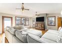 Sunlit living room with sectional sofa, hardwood floors, and a TV at 10489 Quivas St, Northglenn, CO 80234