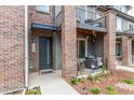 Inviting exterior showcases brick facade, welcoming front door, and a cozy patio area at 5187 S Fairplay St, Aurora, CO 80015