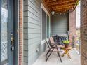 Cozy outdoor patio with seating, a grill, and a wood planked ceiling with string lights at 5187 S Fairplay St, Aurora, CO 80015