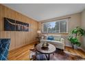 Bright living room with hardwood floors, a large window, and a comfortable seating area at 6940 S Uinta St, Centennial, CO 80112