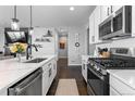 Bright, modern kitchen featuring white cabinets, stainless appliances, and a functional island at 27491 E 10Th Dr, Aurora, CO 80018