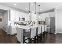 Modern kitchen with stainless steel appliances, white cabinets, and a quartz countertop island at 27491 E 10Th Dr, Aurora, CO 80018