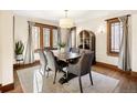 Bright dining room featuring hardwood floors, a large table with seating, and natural light from ample windows at 2591 Albion St, Denver, CO 80207