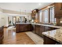 Modern kitchen with granite countertops, stainless steel appliances, and hardwood floors, with dining room view at 2591 Albion St, Denver, CO 80207