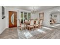 Elegant dining room with wood table, chandelier, and ample natural light, creating a warm and inviting atmosphere at 5173 S Emporia Way, Greenwood Village, CO 80111