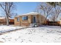 Charming brick ranch home with a snow-covered lawn at 3151 S Corona St, Englewood, CO 80113