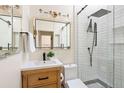 Modern bathroom with a glass-enclosed shower, sleek fixtures, and a wood vanity at 480 S Grant St, Denver, CO 80209