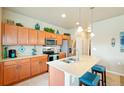 Modern kitchen with a center island, stainless steel appliances, and ample storage at 3595 E 124Th Pl, Thornton, CO 80241