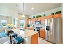 Bright kitchen featuring an island, stainless steel appliances, and ample cabinet space at 3595 E 124Th Pl, Thornton, CO 80241