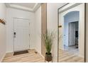 Welcoming entryway features wood-look floors and an elegant accent wall with decorative plant at 6770 Zebra Grass Ln, Parker, CO 80138