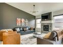 Comfortable living room with a fireplace, large windows and stylish decor at 6770 Zebra Grass Ln, Parker, CO 80138
