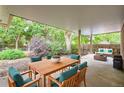 Covered outdoor patio with dining and lounging area, perfect for entertaining at 2648 S Wadsworth Way, Lakewood, CO 80227
