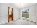 Dining room with neutral carpet, natural light, and an open doorway to kitchen at 16835 E Harvard Pl, Aurora, CO 80013