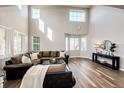 Bright living room with large windows, modern decor, and elegant wood floors at 4968 Montvale Dr, Highlands Ranch, CO 80130