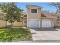 Inviting townhome featuring an attached garage and well-maintained lawn at 15912 E Dakota Pl # C, Aurora, CO 80017