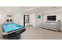 Spacious basement with pool table and seating area, ideal for entertainment at 3193 W 134Th Cir, Broomfield, CO 80020