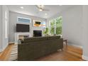 Cozy living room with fireplace, large windows, and hardwood floors at 5988 N Boston St, Denver, CO 80238